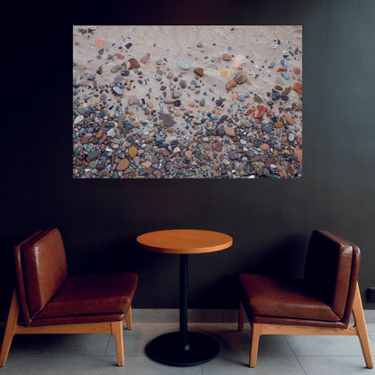 Casual sitting area with dark wall highlighting a fine art wall decor of Nairn Beach Scotland with colorful rocks throughout the sand.  Art by Lisa Blount Photography