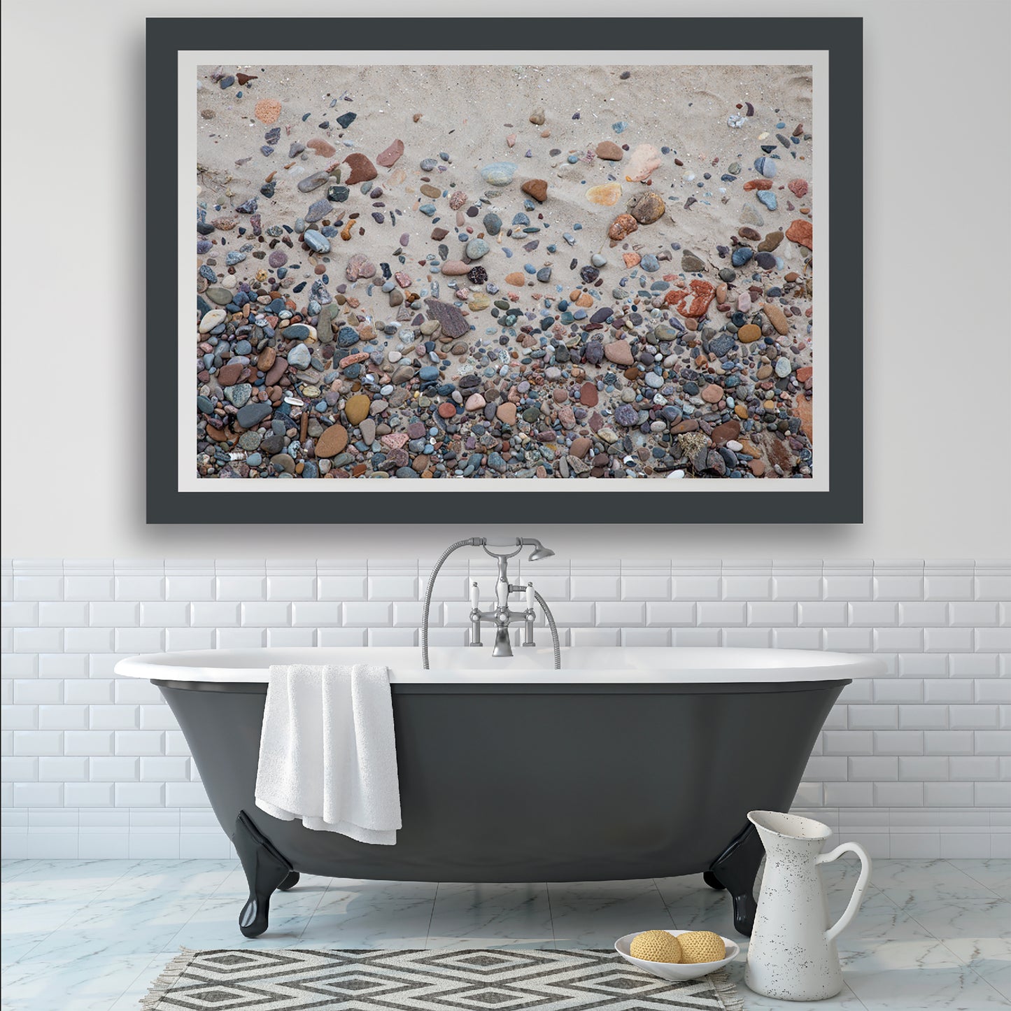 bright white bathroom displaying a large wall art of a sandy beach with colorful rocks as the main focal point wall art decor.  Art by Lisa Blount Photography